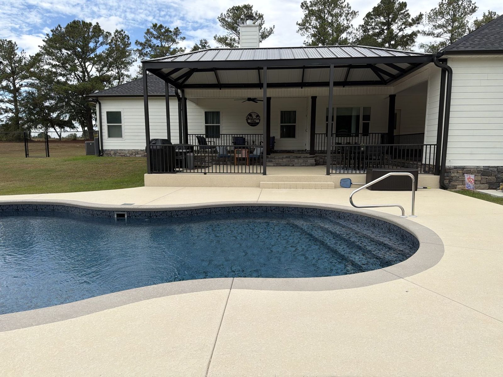 Pool and new covered patio, rear of house